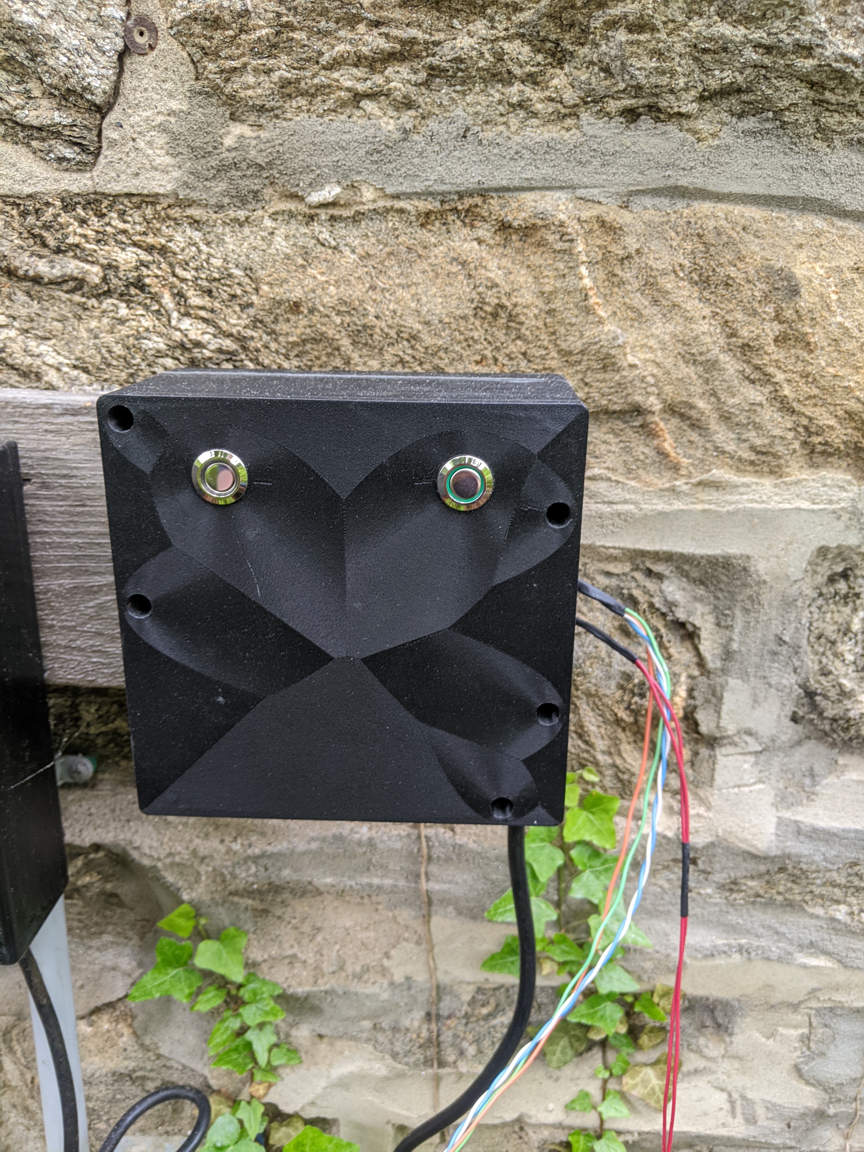 The case for the control board. Mounted to an external stone wall, via a wooden board. The power cable comes out the bottom, the probe and solenoid wires exit to the right.